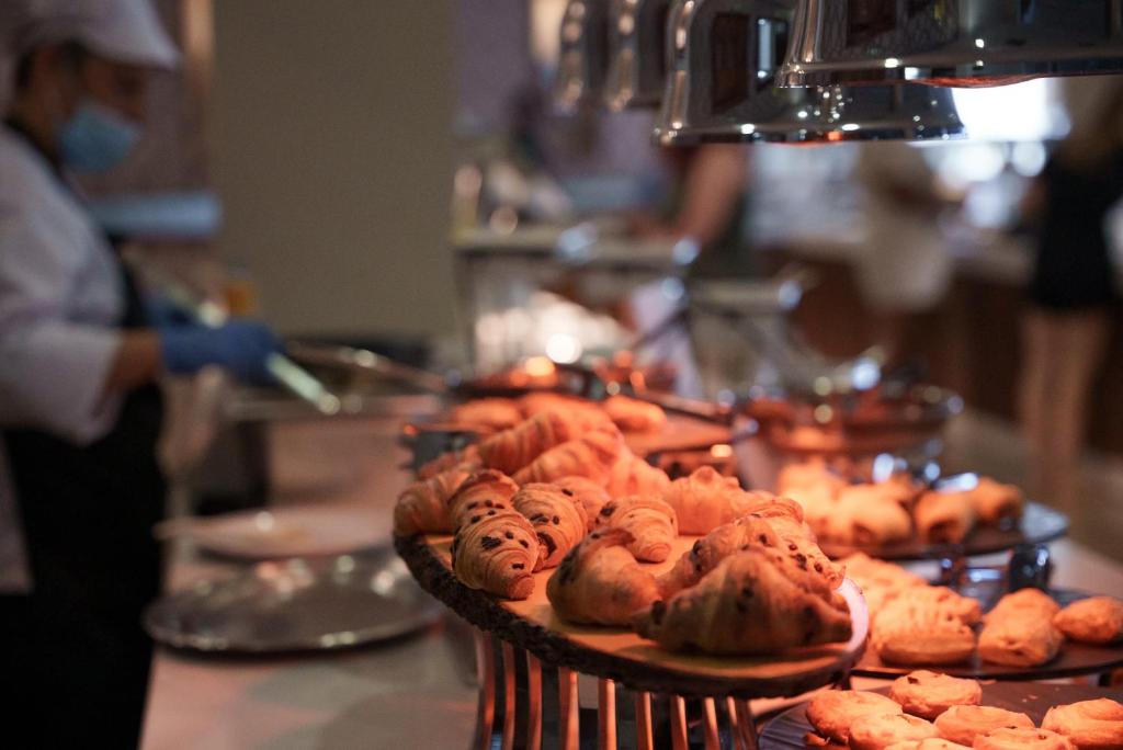 a table with a bunch of pastries on at Pavlo Napa Beach Hotel in Ayia Napa