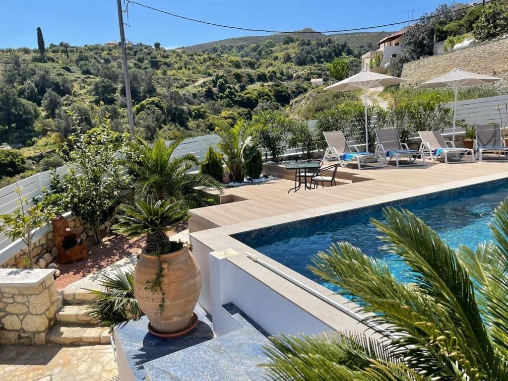 a villa with a swimming pool and a resort at Villa Aspria in Rethymno