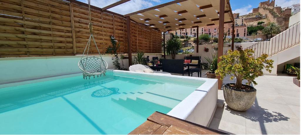 a swimming pool with a swing in a building at Murallas de Jayrán Hotel Boutique in Almería