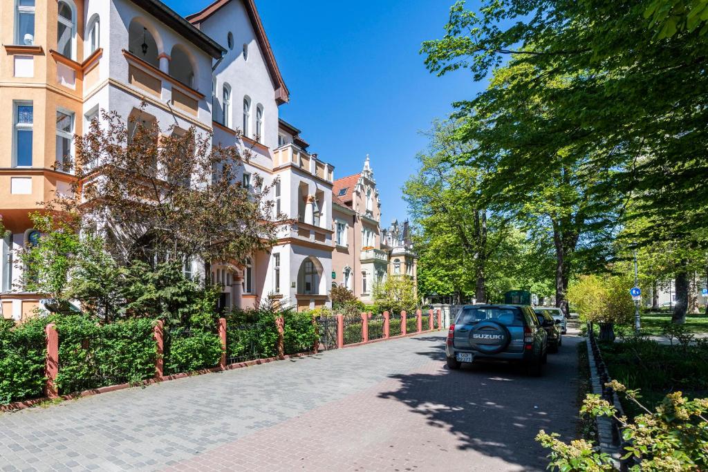 a car parked on a street next to a building at Park Apartment (Parkowy) Happy Hours in Sopot