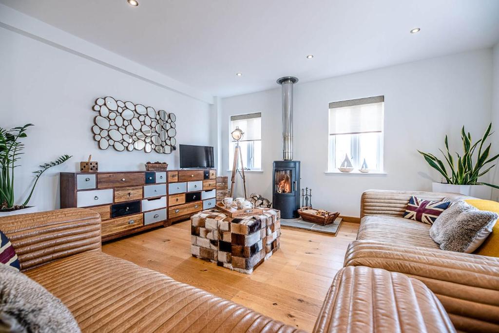 a living room with two couches and a fireplace at Guild House, Aldeburgh in Aldeburgh