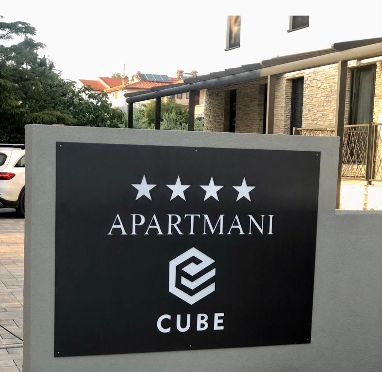 a sign for a apartment building with stars on it at Apartmani CUBE L in Medulin