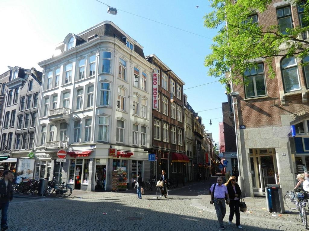 a group of people walking down a city street at Rho Hotel in Amsterdam