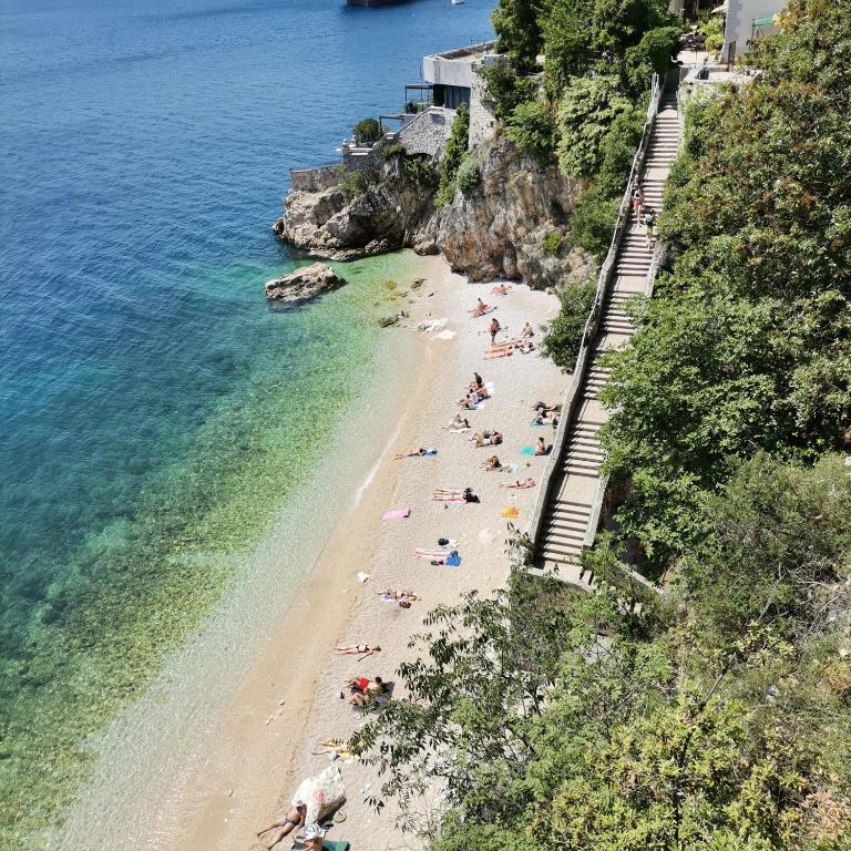 a group of people on a beach near the water at APARTMAN FLAVIA in Rijeka