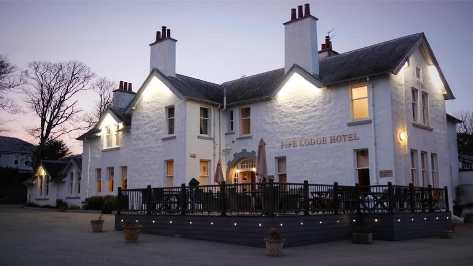 een groot wit gebouw met een bord erop bij Fife Lodge Hotel in Banff