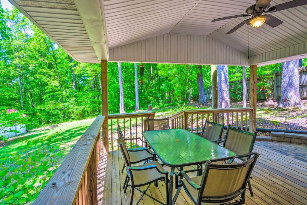 a wooden deck with a table and chairs on it at Dale Hollow Lake Haven Private Yard and Grill! in Albany