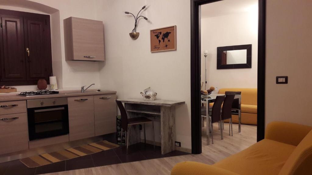 a kitchen with a counter and a table in a room at Borgo Relax in Stroncone