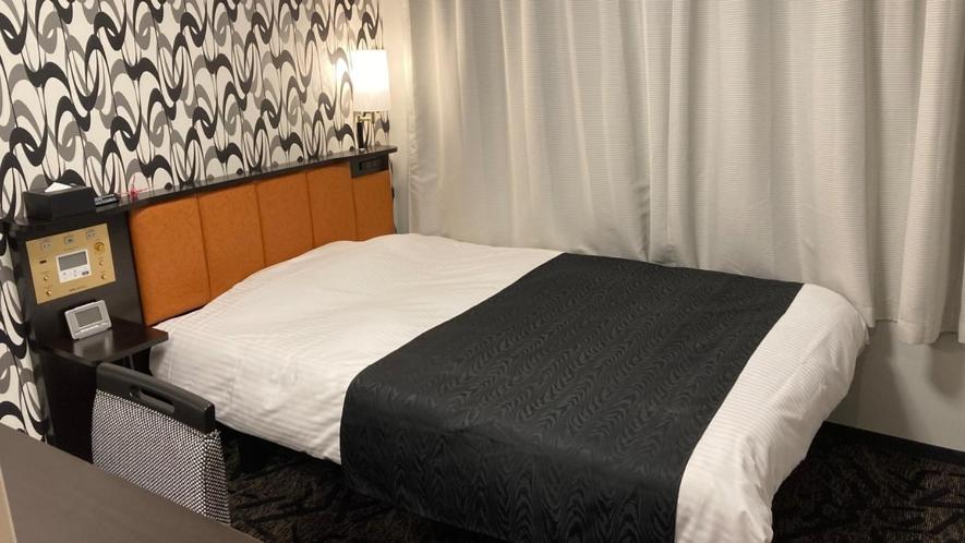 Postel nebo postele na pokoji v ubytování APA Hotel Beppu Ekimae