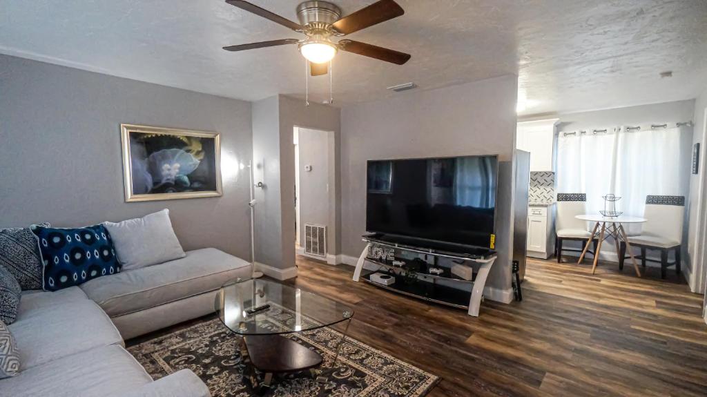 a living room with a couch and a flat screen tv at Elegant Cozy Oasis on a traffic free street in Clearwater