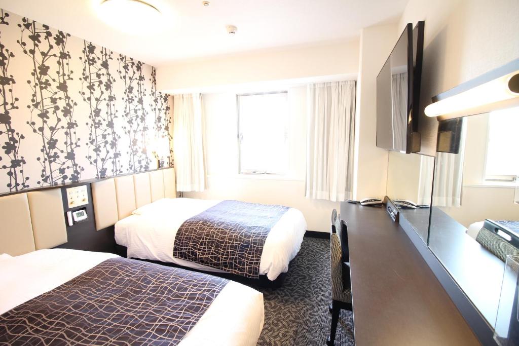 Postel nebo postele na pokoji v ubytování APA Hotel Beppu Ekimae