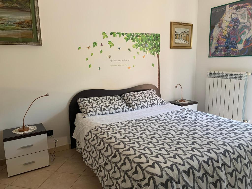a bedroom with a bed with a black and white comforter at La Dimora di Paola in Lecce
