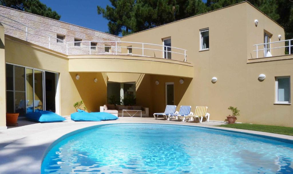 a large swimming pool in front of a house at Aroeira Villa near Lisbon- Daydream PT in Charneca