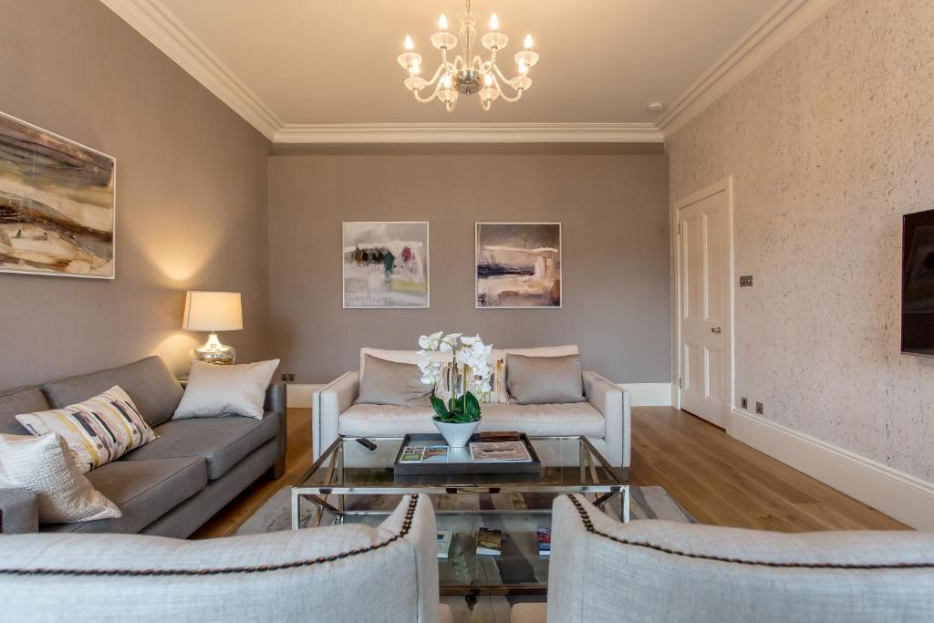 a living room with a couch and a table at Exclusive 2 Bed, Free Private Parking, in West End in Edinburgh