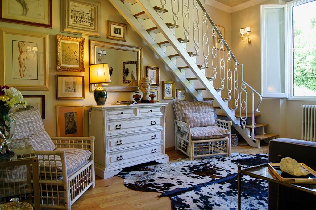 a living room with a staircase and a dresser at Greenhouse in Florence