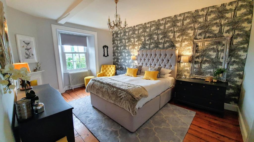 a bedroom with a large bed and a wall at Rock View, Wensleydale in Leyburn