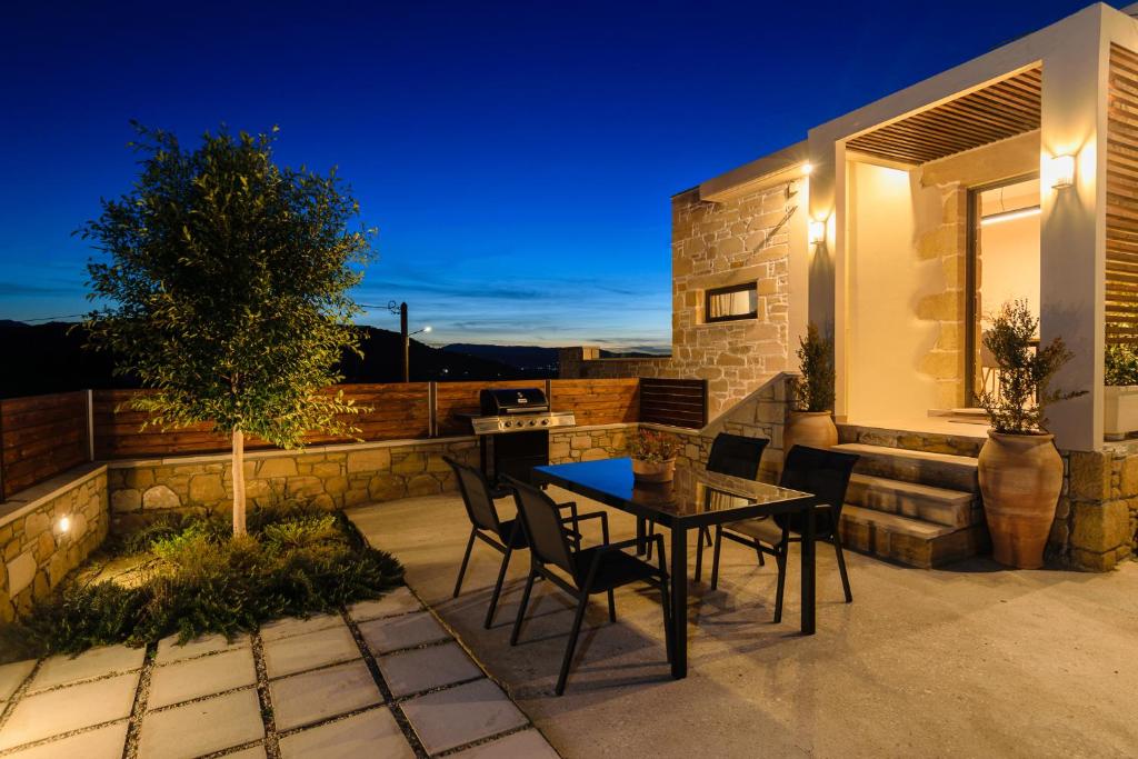 a patio with a table and chairs on a balcony at Effrosini Panorama View in Nopíyia