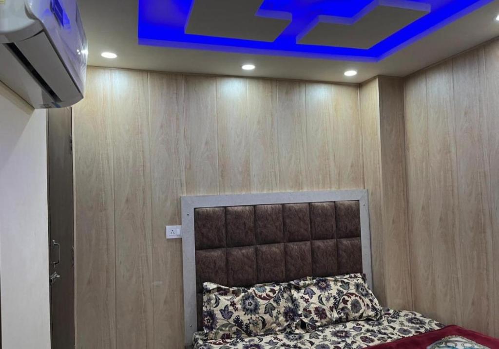 a bedroom with a bed and a blue ceiling at Hotel Star Inn in Amritsar