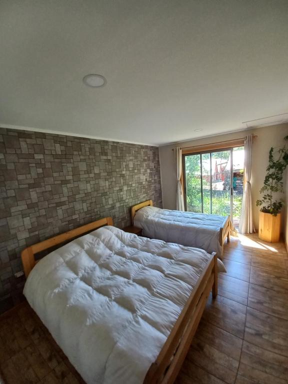Letto o letti in una camera di Cabañas Golem - Camino Termas de Chillán