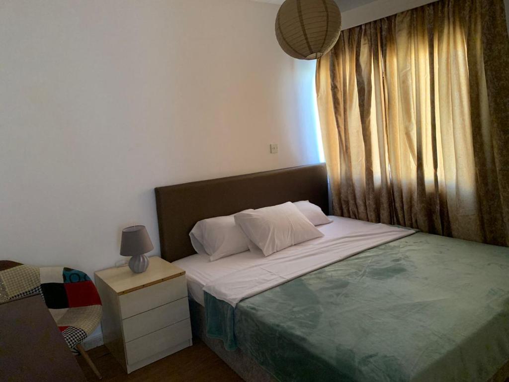 a small bedroom with a bed and a window at Green Nondas Hill in Larnaka