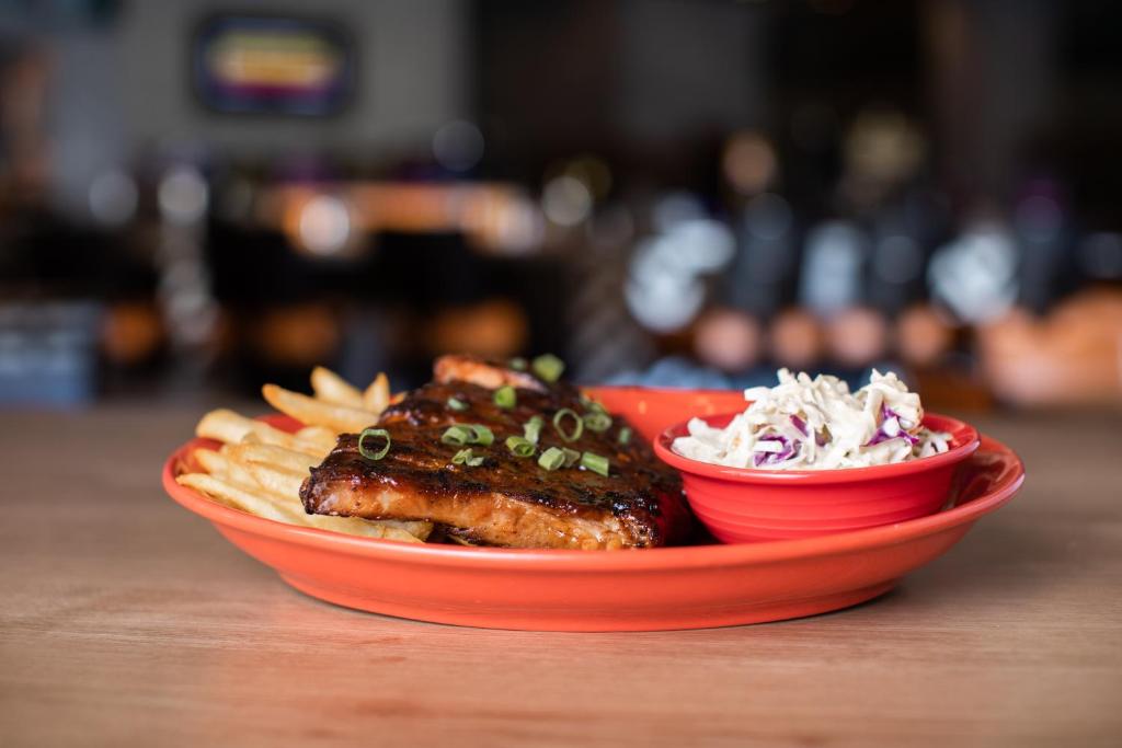 a red plate of food with meat and french fries at Gold Country Casino Resort in Oroville