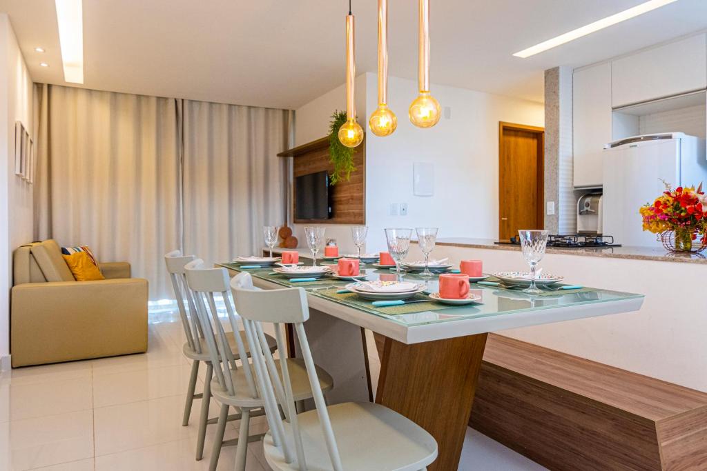 a kitchen and living room with a table and chairs at Solar Porto Rico in Porto De Galinhas