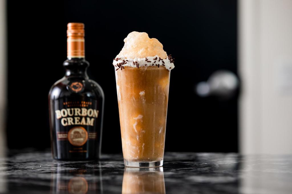 a glass with a drink and a bottle of bourbon crazy at Gold Country Casino Resort in Oroville
