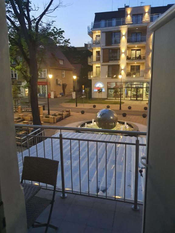 a view from a balcony of a building with a fountain at Apartament Sto Metrów Od Morza in Świnoujście
