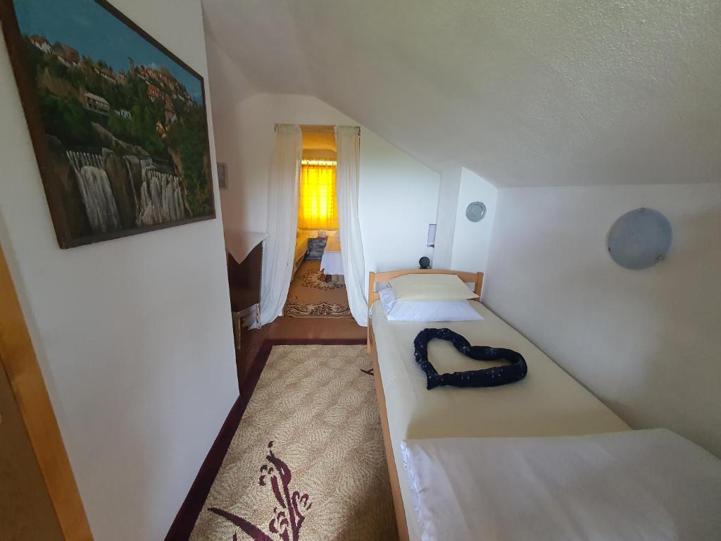 a small room with a bed and a hallway at Privatni smještaj Kurtalija in Jajce