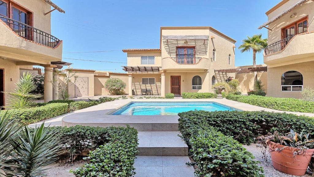 a house with a swimming pool in the yard at Villa Sonari 4, Inside a private complex of 4 By Kivoya in Puerto Peñasco