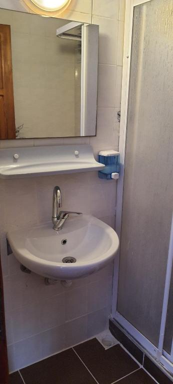 a bathroom with a sink and a mirror at Grand Yayla Hotel in Çeşme