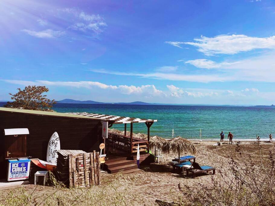 a building on a beach next to the ocean at Lovely studio apartment on the beach in Burgas City