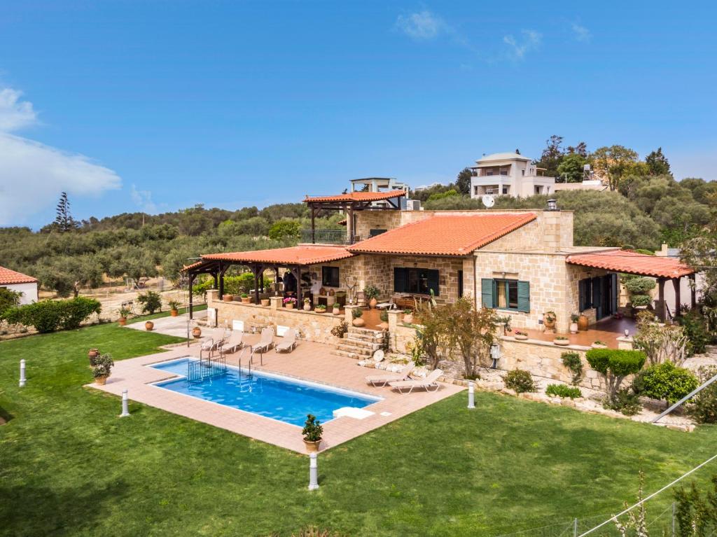 an aerial view of a house with a swimming pool at Athina Traditional Villa in Stalos