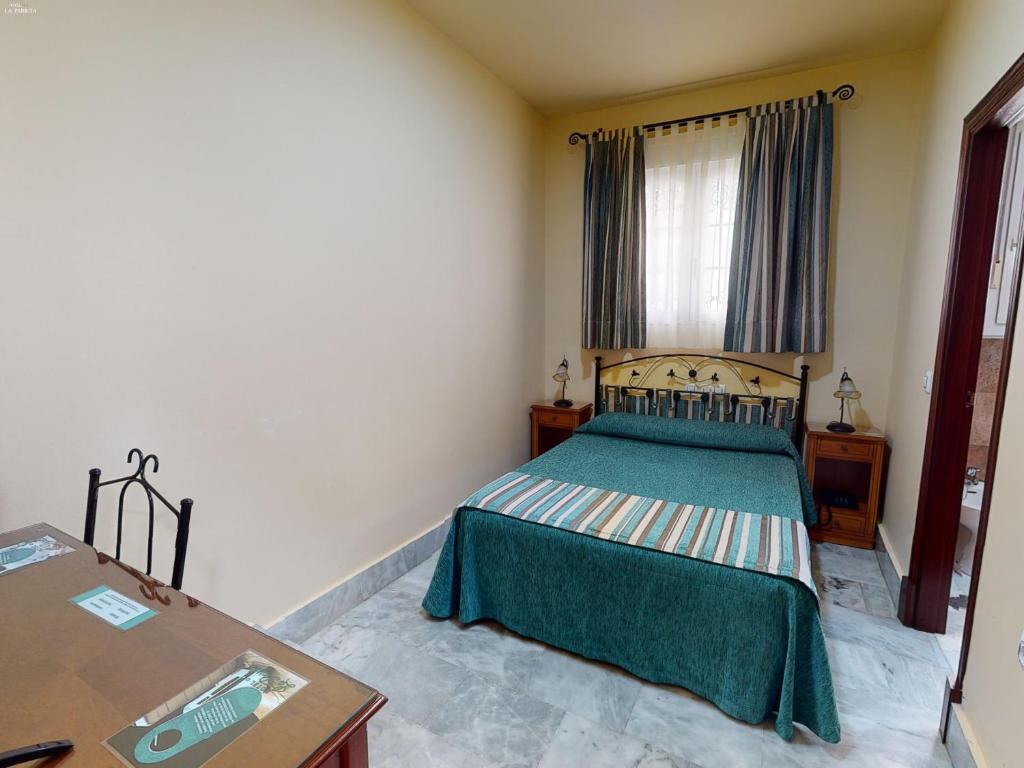 Łóżko lub łóżka w pokoju w obiekcie Hotel La Parrita