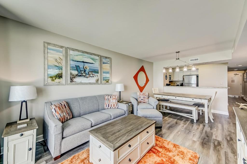 a living room with a couch and a table at Caribbean Resort and Villas 1107 in Myrtle Beach