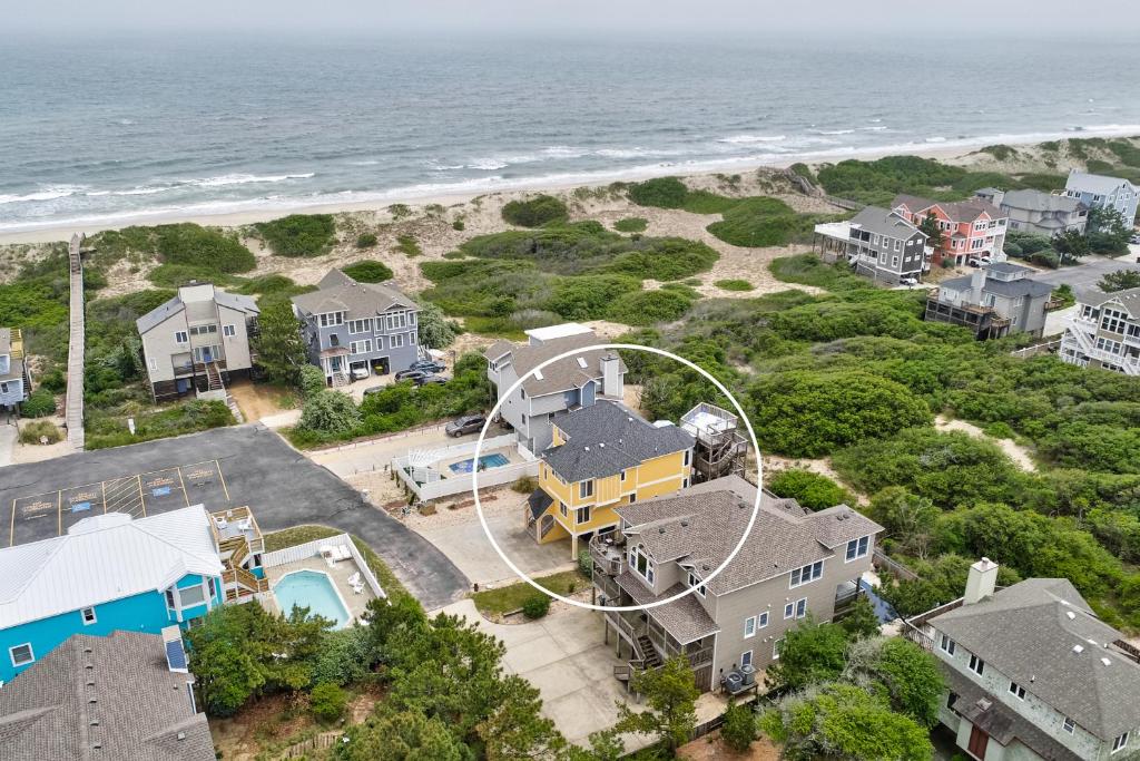 an aerial view of a house next to the beach at Here Comes the Sun in Corolla