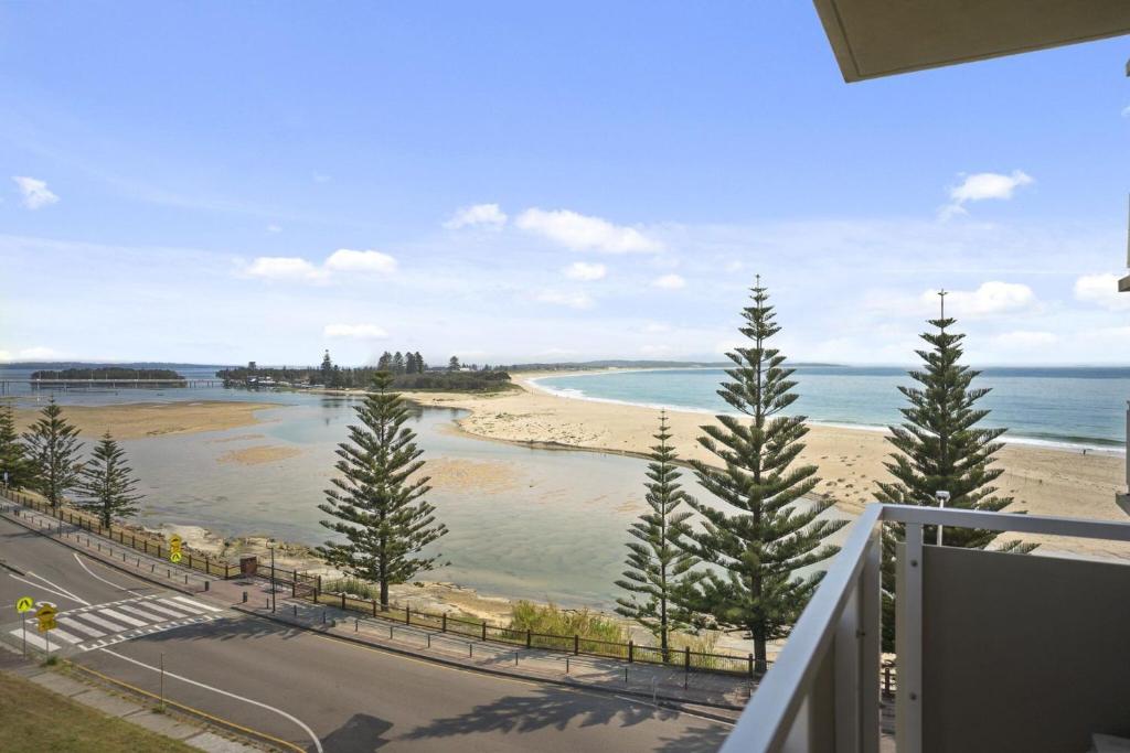 a balcony with a view of a beach and the ocean at Tasman Towers Unit 13 in The Entrance