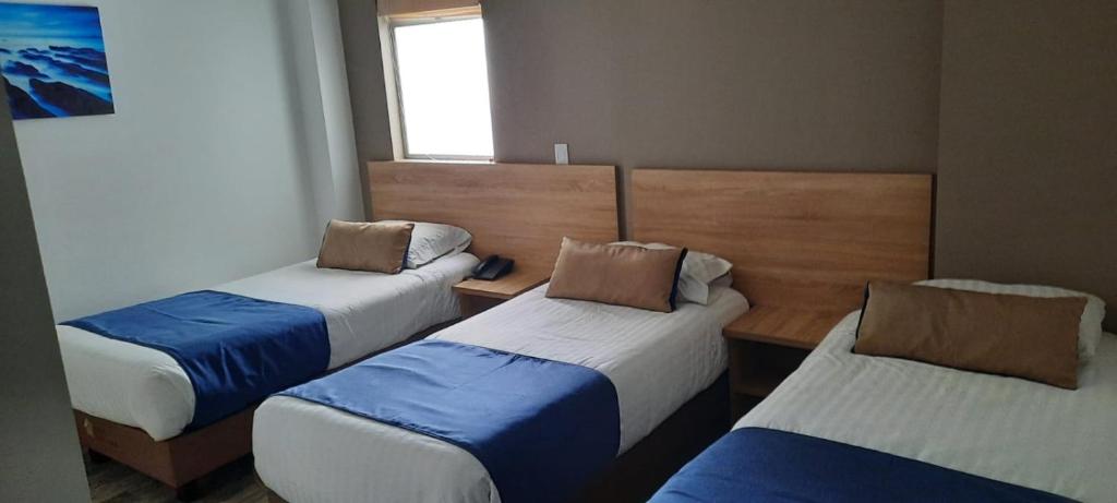 Postel nebo postele na pokoji v ubytování HM HOTEL Expo Inn
