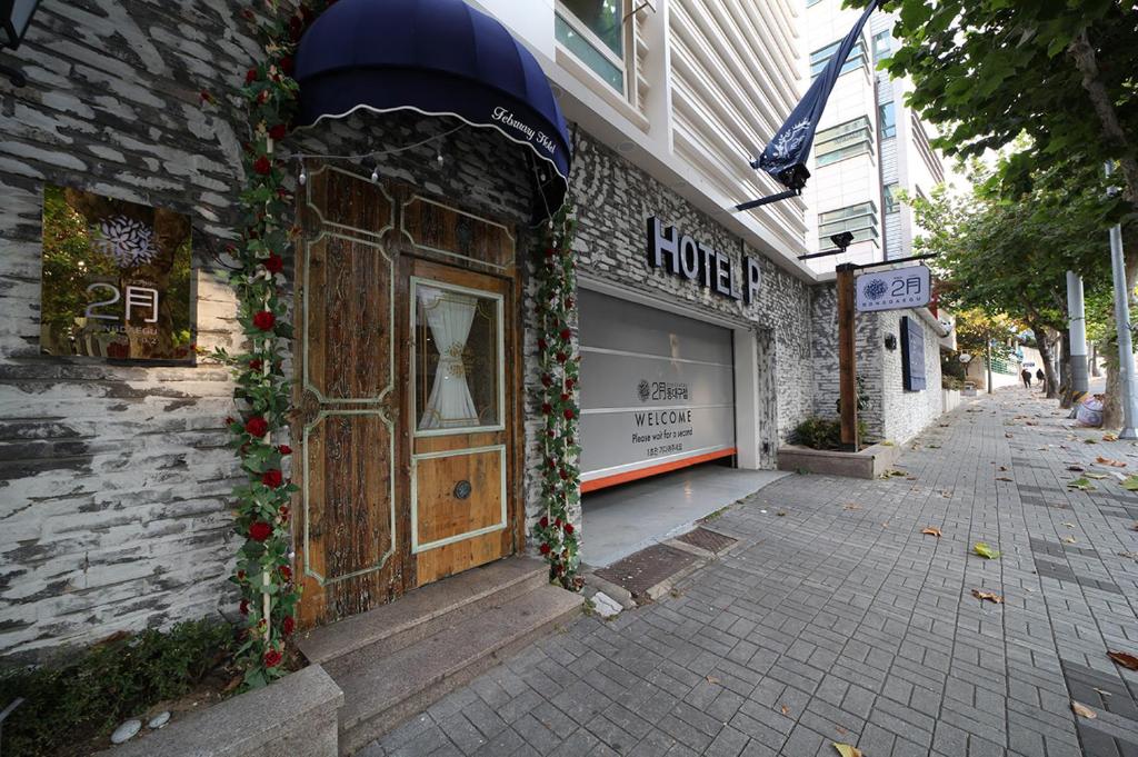 a building with a store front with flowers on it at Daegu February Hotel DongdaeguStation in Daegu