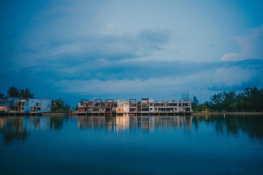 a building sitting on the water in the middle of a lake at Canoe and Fishing , Free Pickup in Batam Center