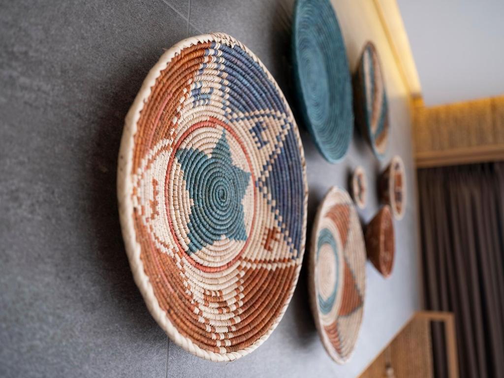 a plate hanging on a wall with utensils at Sa'Rezya Hotel in Çeşme