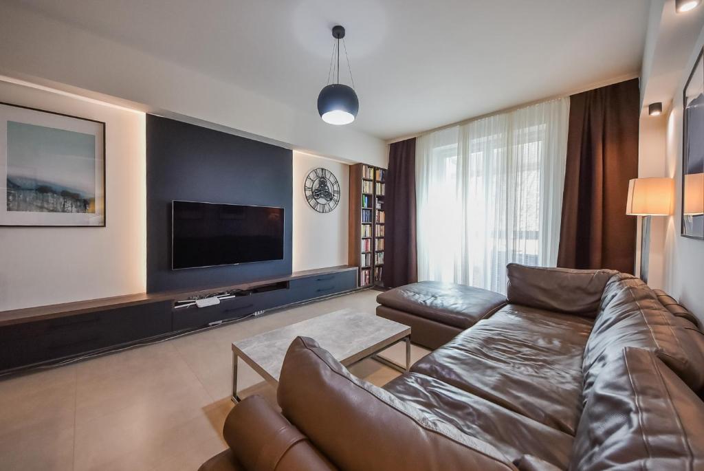 a living room with a couch and a flat screen tv at City Komfort Terrace in Košice