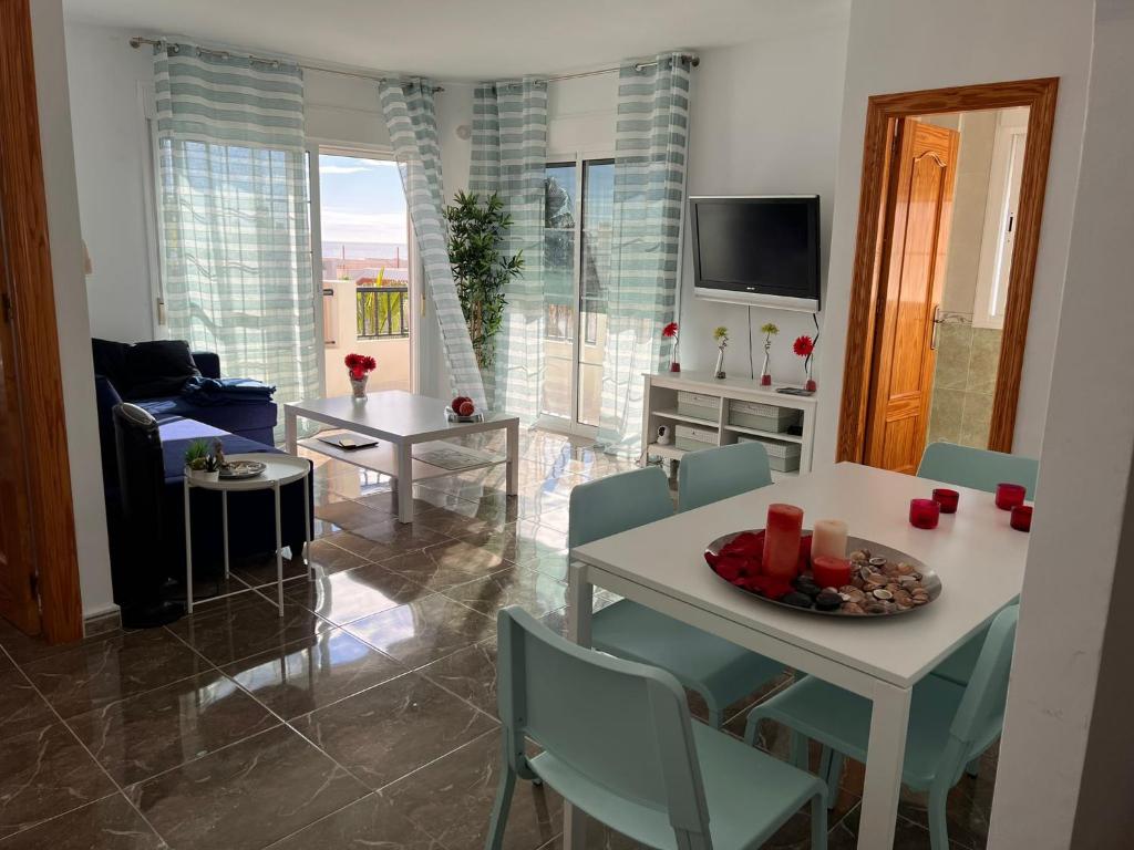 a living room with a white table and chairs at Apartamento Carboneras playa - 2 Habitaciones in Carboneras