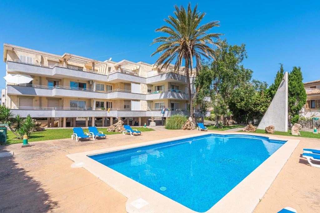 a villa with a swimming pool in front of a building at Veleta ll in Pollença