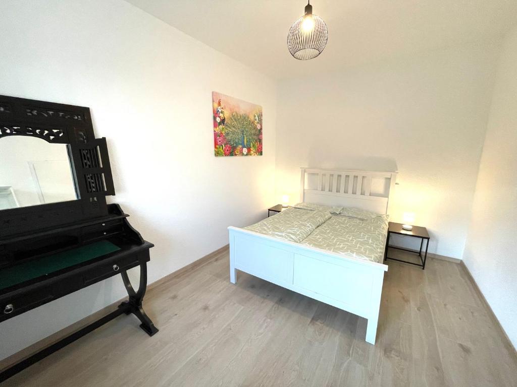 a bedroom with a bed and a mirror and a piano at Sofia Apartments in Baden-Baden