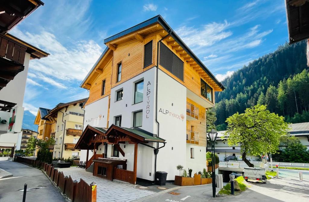 a building in the middle of a street at Quality Hosts Arlberg - ALPtyrol Appartements in Sankt Anton am Arlberg