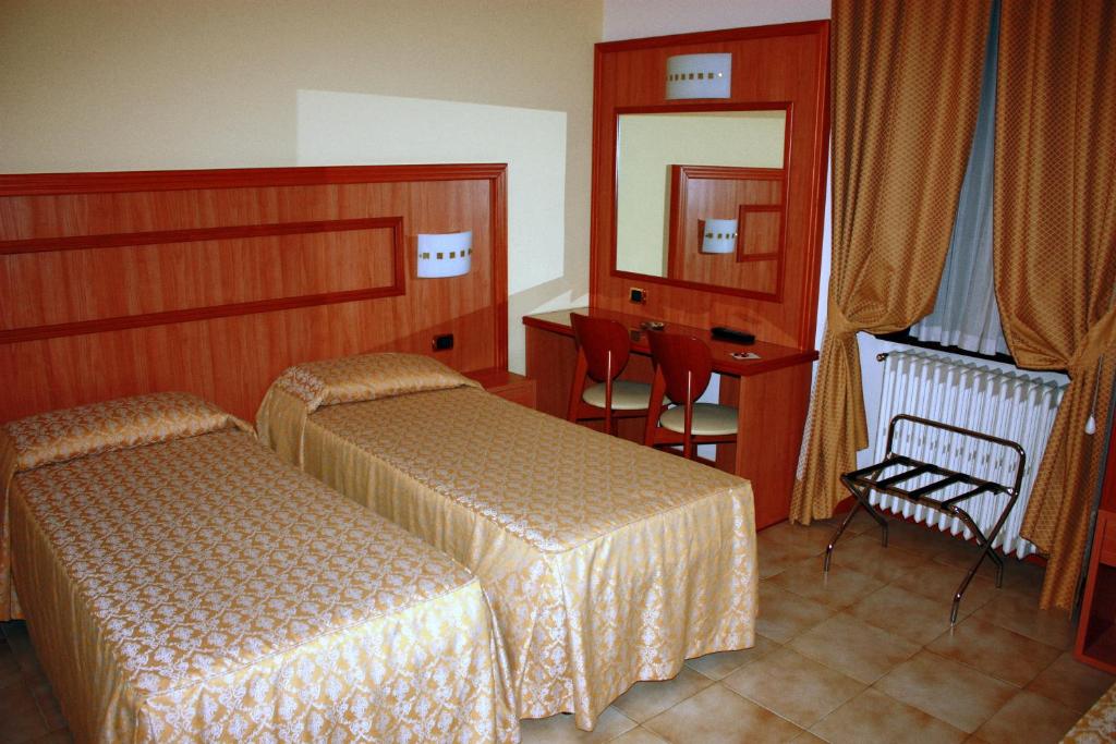 Postel nebo postele na pokoji v ubytování Piccolo Hotel
