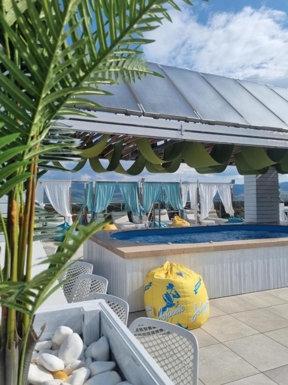 a patio area with chairs and umbrellas at 103 Degrees Hotel & Spa in Sapareva Banya