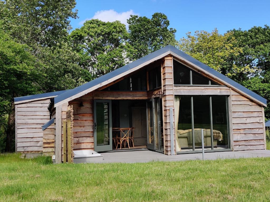 eine kleine Holzhütte mit einem großen Fenster in der Unterkunft The Hare's Shack in Kendal