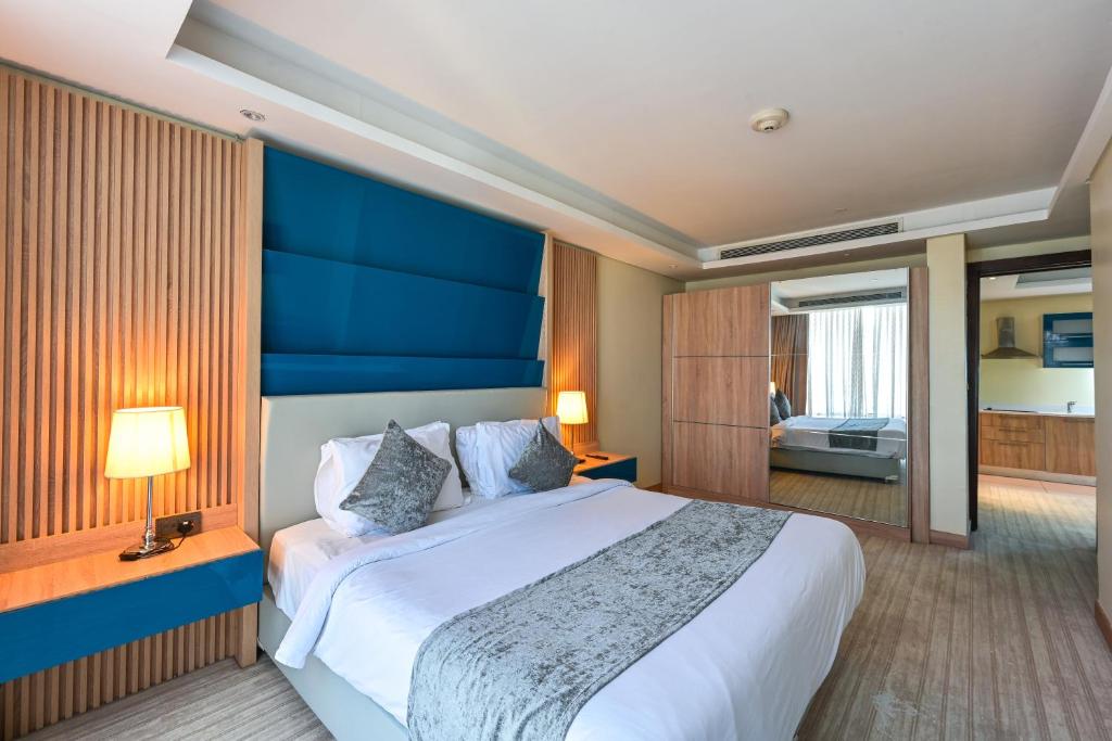 A bed or beds in a room at Al Mansour Suites Hotel