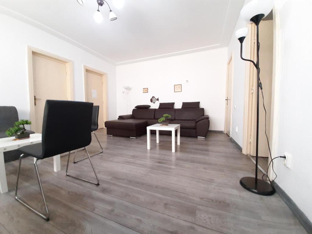a living room with a couch and a table at Four Rooms Apartment Central in Bucharest